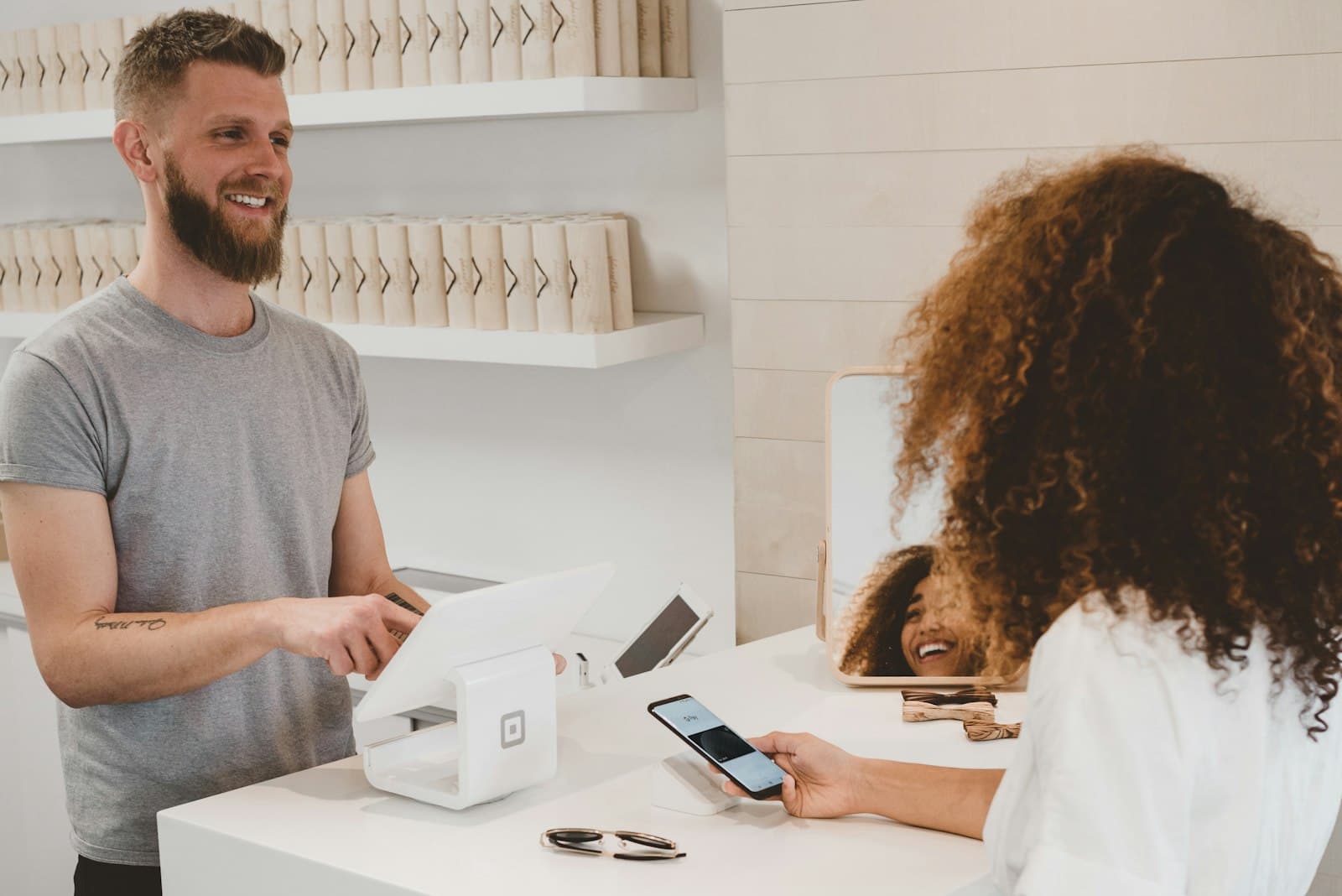 Customer paying by phone at a bright boutique checkout