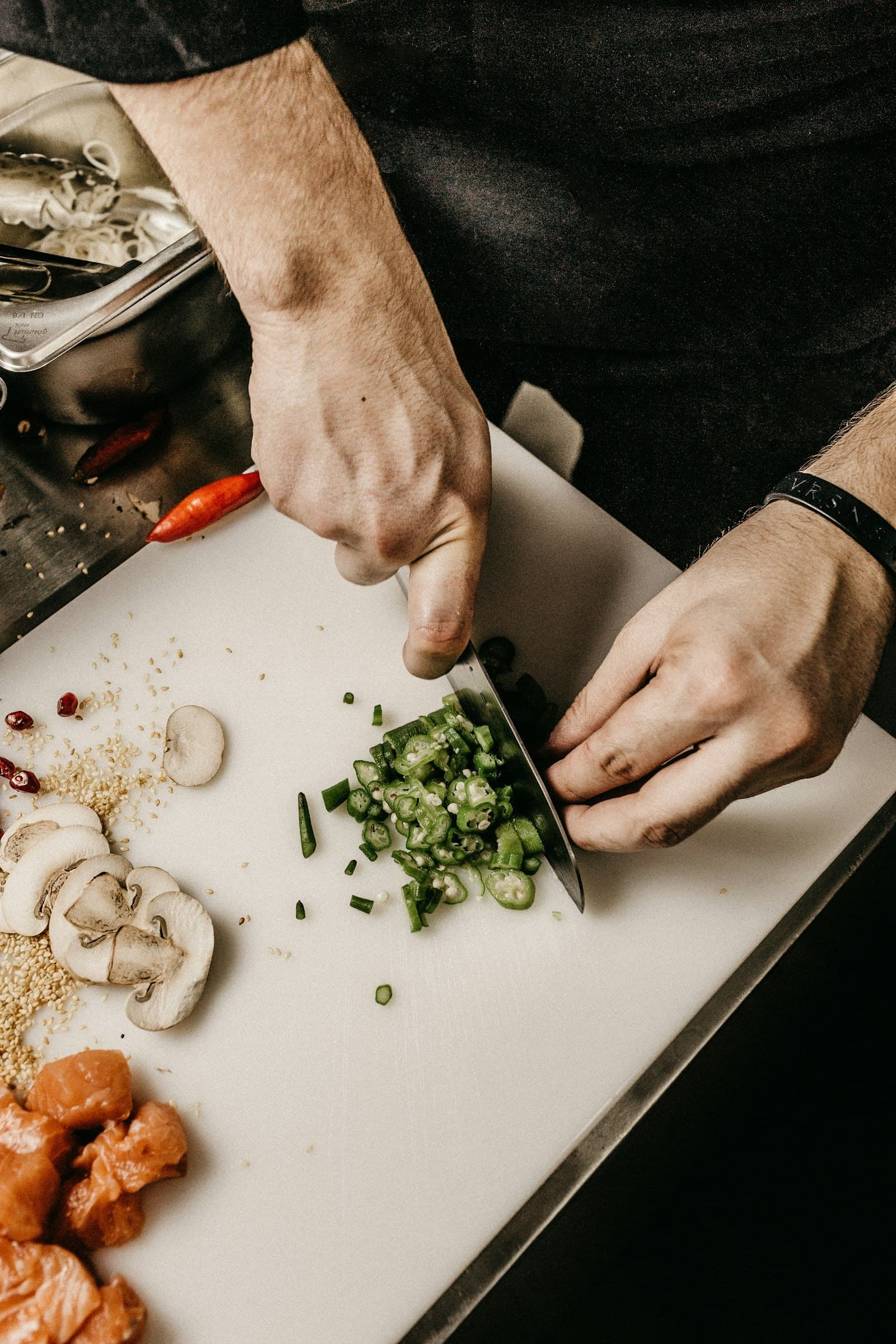 Chef finely chopping herbs on a cutting board