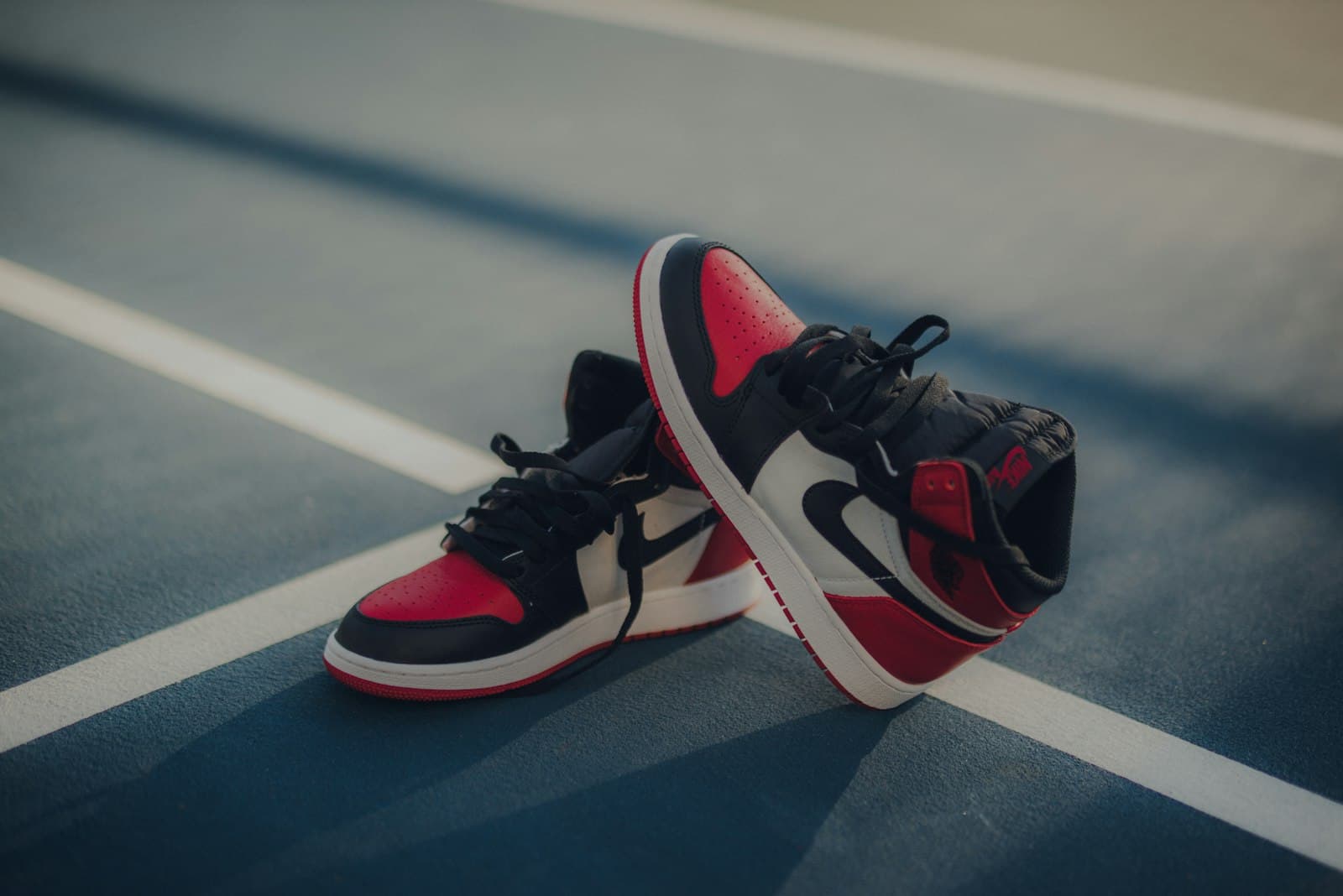 High-top sneakers resting on an outdoor court at dusk